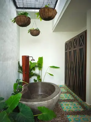 a bathroom with a large tub with plants in it at Casa Amarilla in Honda