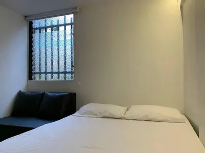 a bedroom with a white bed and a window at Acogedor Apartamento Urbanización Tricentenario in Medellín