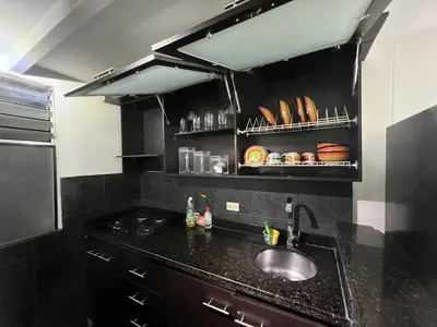 a kitchen with a sink and a counter top at Medellin parque lleras poblado palmas in Medellín