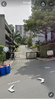an empty street with arrows pointing down a city street at Medellin parque lleras poblado palmas in Medellín