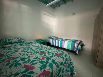 a bedroom with two beds in a room with a comforter at Excelente apartamento Envigado - Full Equipamento. in Envigado