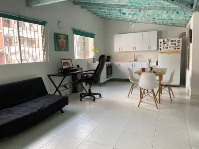 a living room with a couch and a table at Excelente apartamento Envigado - Full Equipamento. in Envigado