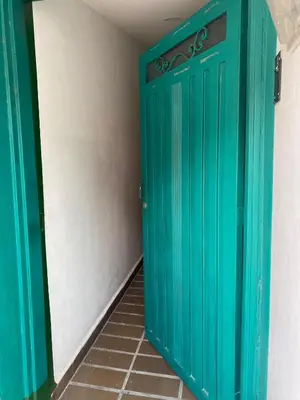 a green door in a room with a tile floor at Excelente apartamento Envigado - Full Equipamento. in Envigado