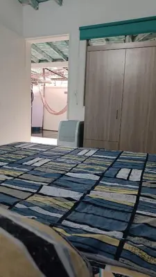 a room with a bed with a quilt on it at Excelente apartamento Envigado - Full Equipamento. in Envigado