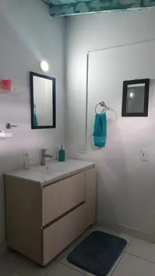 a bathroom with a sink and a mirror at Excelente apartamento Envigado - Full Equipamento. in Envigado
