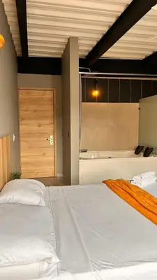 a bedroom with a large bed and a bath tub at Seven hotel in Santa Fe de Antioquia