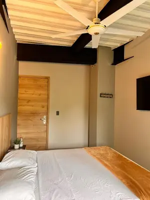 a bedroom with a bed and a ceiling fan at Seven hotel in Santa Fe de Antioquia