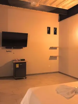 a room with a flat screen tv on a wall at Seven hotel in Santa Fe de Antioquia