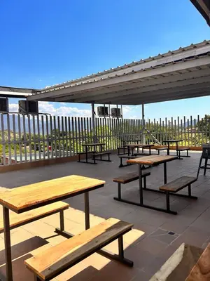 a group of picnic tables on a patio at Seven hotel in Santa Fe de Antioquia