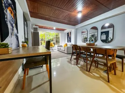 a dining room and living room with a table and chairs at Cerca a provenza. Amplio. Con todo cerca 273 DG in Medellín