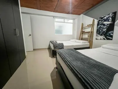 a room with three beds and a window and a ladder at Cerca a provenza. Amplio. Con todo cerca 273 DG in Medellín