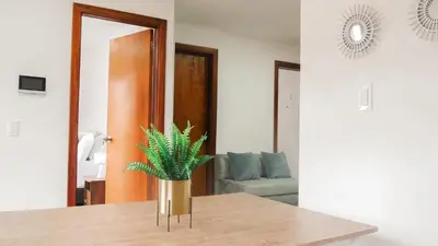 a vase with a plant on a table in a room at OCASSO JARDIN APARTAMENTO AZULEJO in Jardin