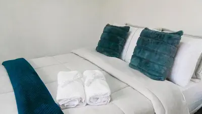 a white couch with two pillows and towels on it at OCASSO JARDIN APARTAMENTO AZULEJO in Jardin