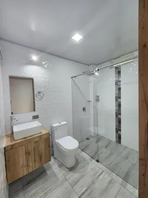 a bathroom with a toilet and a sink and a shower at Hotel nelumbo in Mariquita
