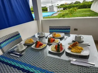 a table with plates of food on top of it at Hotel nelumbo in Mariquita