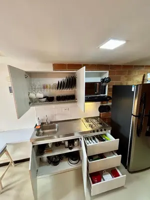 a kitchen with a sink and a refrigerator at Increíble Apartaestudio Cerca al Centro Comercial Los Molinos in Medellín