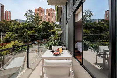 a balcony with a table and chairs and a view of the city at Kiin Living- 