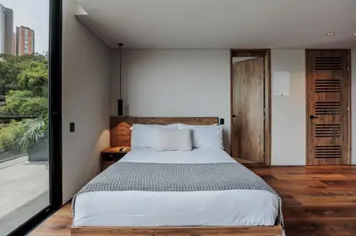 a bedroom with a large bed and a large window at Kiin Living- 