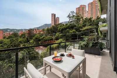 a white table and chairs on a balcony with a view at Kiin Living- 