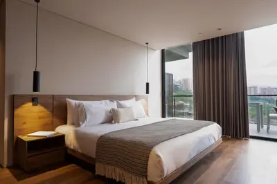 a bedroom with a large bed and a large window at Kiin Living- 