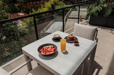 a table with a bowl of fruit and a glass of orange juice at Kiin Living- 