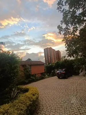 a car parked on a brick road in front of a building at Casa Campestre con terraza para 10 Poblado S Lucas 108 in Medellín