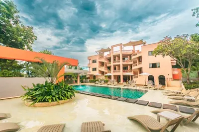 a resort with a swimming pool and lounge chairs at Del Trópico Hotel By GyC Hotels in Sopetran