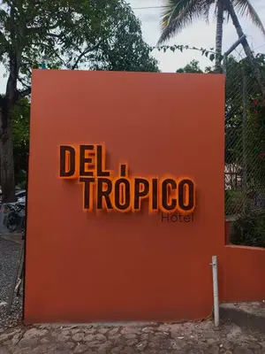 an orange sign that says delphi tropico hotel at Del Trópico Hotel By GyC Hotels in Sopetran