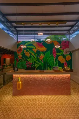 a wall with a mural of flowers and plants at Del Trópico Hotel By GyC Hotels in Sopetran
