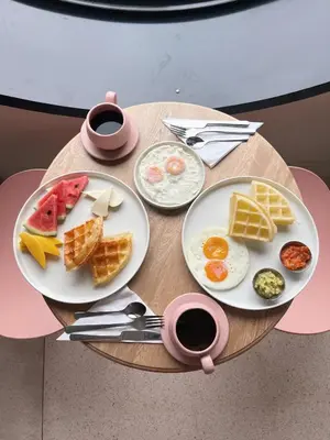 a table with two plates of breakfast food on it at Del Trópico Hotel By GyC Hotels in Sopetran
