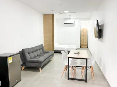a living room with a couch and a table and chairs at Loft del Río Honda - Apartaestudio completo con parqueadero y aire acondicionado in Honda