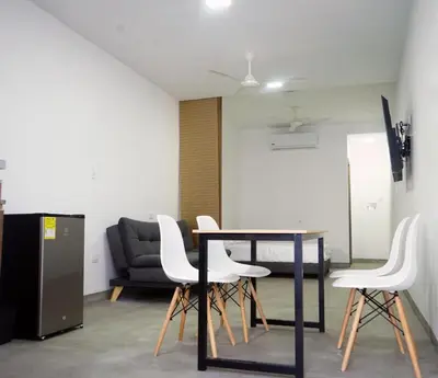 a table and chairs in a room with a couch at Loft del Río Honda - Apartaestudio completo con parqueadero y aire acondicionado in Honda