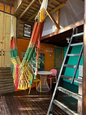 a room with a hammock and a table and a ladder at LA CASA EN EL AIRE - Abejorral in Abejorral