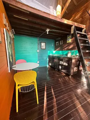 a dining room with a table and a yellow chair at LA CASA EN EL AIRE - Abejorral in Abejorral
