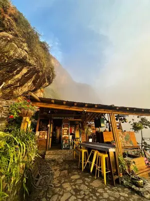 a building with a table and chairs in front of it at LA CASA EN EL AIRE - Abejorral in Abejorral