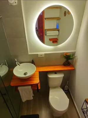 a bathroom with a sink and a toilet and a mirror at Hospedaje Oasis Blue Laureles Medellín in Medellín