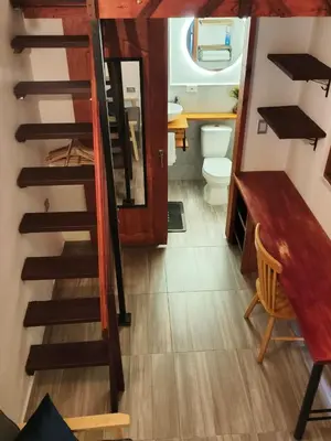 a bathroom with a staircase with a toilet and a sink at Hospedaje Oasis Blue Laureles Medellín in Medellín