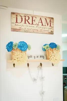 a dream sign hanging on a wall with blue flowers at Amplio duplex con terraza privada. in Medellín