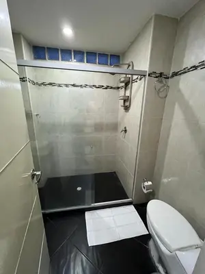 a small bathroom with a toilet and a shower at AMOBLADO LOS MOLINOS in Medellín
