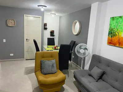 a living room with a couch and a table at AMOBLADO LOS MOLINOS in Medellín