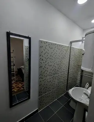 a bathroom with a shower and a sink and a mirror at SAN SENDERISMO ROOM in Mariquita