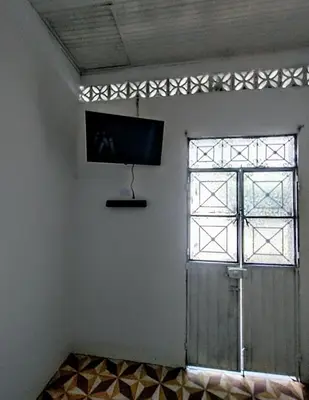 a room with a door and a tv on the wall at SAN SENDERISMO ROOM in Mariquita