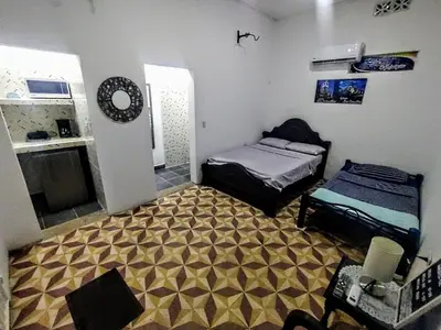 a small room with two beds and a kitchen at SAN SENDERISMO ROOM in Mariquita