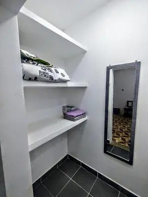 a room with white shelves with a mirror and a car at SAN SENDERISMO ROOM in Mariquita