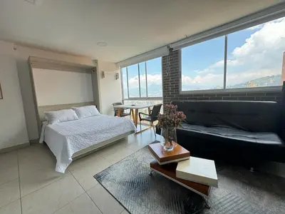 a living room with a bed and a couch at Apto Familiar in poblado in Medellín