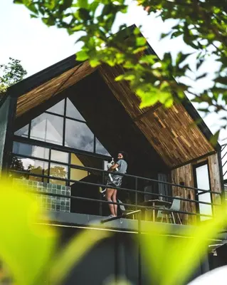 a man standing on the balcony of a house at Ceiba del Agua in San Rafael