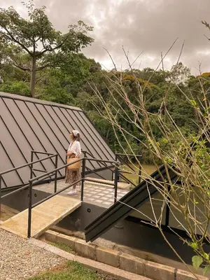 a woman is standing on a bridge over some stairs at Ceiba del Agua in San Rafael