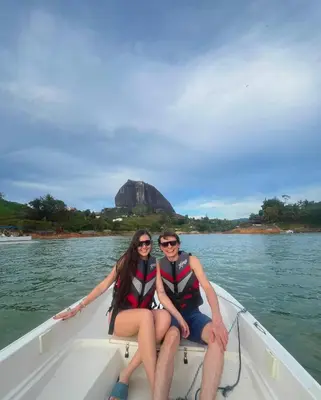 two people sitting in a boat on the water at Refugio del Lago in Guatapé