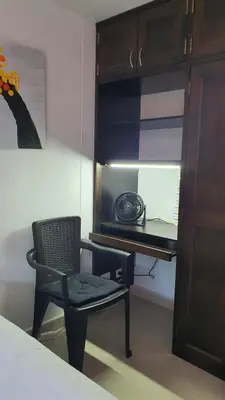 a black chair and a desk in a room at Habitación en apartamento compartido en Envigado in Envigado