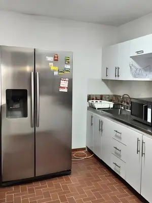 a kitchen with a stainless steel refrigerator at CASA ESTADIO MEDELLIN Amplio Apartamento Renovado para Familias, Grupos o Delegaciones Deportivas cerca al Estadio Atanasio Girardot - Laureles-Estadio in Medellín